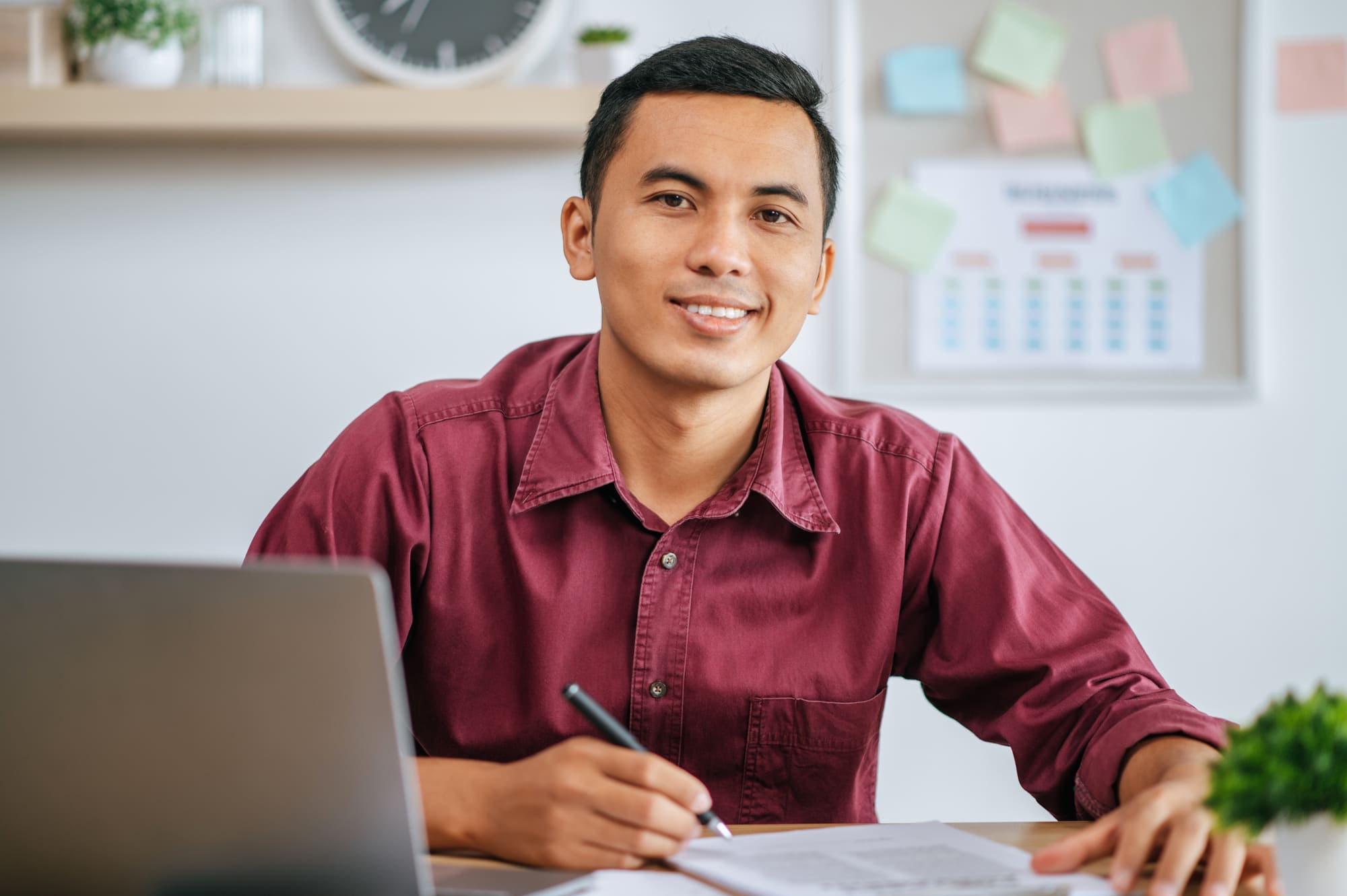 man-working-office-with-papers-laptop-desk (1) (1)